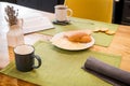 On linen towel on a wooden table, simple breakfast of two mugs of coffee, and slices of bread and cheese Royalty Free Stock Photo