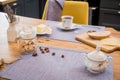 On linen towel on a wooden table, simple breakfast of two mugs of coffee, and slices of bread and cheese Royalty Free Stock Photo