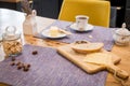 On linen towel on a wooden table, simple breakfast of two mugs of coffee, and slices of bread and cheese Royalty Free Stock Photo