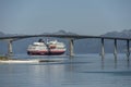 Liner cruising under high bridge near Stokmarknes, Norway