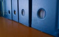 lines of blue file folders on wooden table Royalty Free Stock Photo