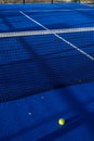 Lines, blue paddle tennis net and court field background with a yellow ball Royalty Free Stock Photo