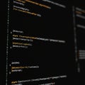 Lines of code are displayed on a dark computer screen. The text appears to be written Royalty Free Stock Photo