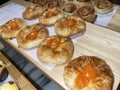 Lines of fresh baked sweet puff pastry stuffed with apricot and peach jelly Royalty Free Stock Photo