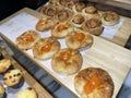 Lines of fresh baked sweet puff pastry stuffed with apricot and peach jelly Royalty Free Stock Photo