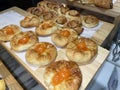 Lines of fresh baked sweet puff pastry stuffed with apricot and peach jelly Royalty Free Stock Photo