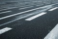 Lines on wet wide asphalt road perspective view.