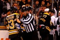 Linesman Bryan Pancich restrains Brad Marchand.