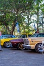 A lineup of classic American cars on Hotrodiningrat parking lot