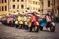 A lineup of motor scooters neatly parked next to one another in a row, Retro Vespa scooters in different shades parked in a