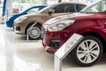 A lineup of new cars on display inside a showroom or dealership. Concept of auto market business in Asia Royalty Free Stock Photo