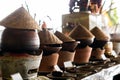 A lineup of traditional clay pot rice warmers, topped with iconic bamboo hats, evoking the warmth and authenticity of Asian Royalty Free Stock Photo