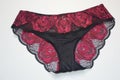 Lingerie. Sexy black panties with bright pink lace on a white background Royalty Free Stock Photo