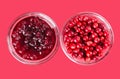 Lingonberry jam and lingonberries in glass bowls over pink