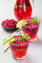 Lingonberry and lime punch or limeade in glass and pitcher on gray background, vertical Royalty Free Stock Photo