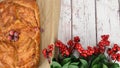 Lingonberry sprigs and a puff pastry pie with apples and cranberries, laid out on a whiteboard table Royalty Free Stock Photo