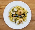 Linguine allo scoglio, dish of italian pasta with seafood on wooden table