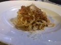 Linguine Bolognese with cheese . Close