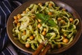 Linguine pasta with chickpeas and green pesto in a rustic decor