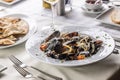 Linguine pasta with mussels and grated pecorino cheese on top served in a restaurant Royalty Free Stock Photo