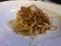 Linguini Bolognese with cheese . Top view