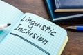Linguistic inclusion written in a notebook. Diversity and equitable communication. Royalty Free Stock Photo