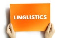 LINGUISTICS text on card held by hands, concept of language, communication, and grammar study Royalty Free Stock Photo