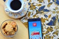 link aja apps on smartphone with coffe and cake foto concept