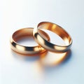 linked gold wedding rings displayed on a clean white background Royalty Free Stock Photo