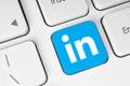 LinkedIn icon key on white computer keyboard close-up. Concept of process in popular social media services. LinkedIn is business