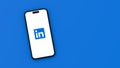 Linkedin Logo on Mobile Phone Screen on Blue Background with Copy Space