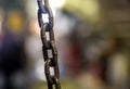 Links of a metal cast iron chain stretched close-up