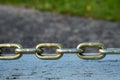 Links of taut steel chain over wood Royalty Free Stock Photo