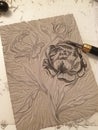 Lino cut of peonies with the cutting knife
