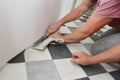 Linoleum, also called lino installation.   Worker hands installing Linoleum on the house room floor Royalty Free Stock Photo