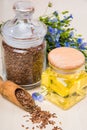 Linseed oil, flax seeds, and flowers on a light background. Royalty Free Stock Photo