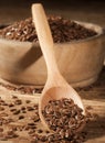 Linseed. Spoon and bowl of linseeds on wooden background Royalty Free Stock Photo