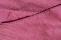 Lints on pink sweater. Acrylic or wool sweater. Before cleaning and collected fluff lint. Closeup Pilled sweater. Old