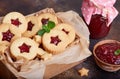 Linzer Christmas cookies with stars. Delicious biscuits with raspberry jam.