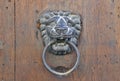 Lion door knocker on old wooden door Royalty Free Stock Photo