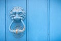 Lion head door knocker on an old wooden door