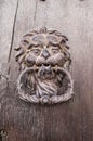 Lion head, Door knocker on old wooden door Royalty Free Stock Photo