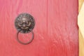 lion head door knocker at the red wooden door. Royalty Free Stock Photo