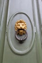 Lion head knocker on green door in Florence