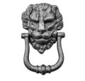 Lion head knocker on an old white wooden door