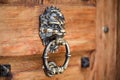 Lion head knocker on an old wooden door. Vintage door Royalty Free Stock Photo