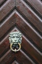 The lion head knocker with the ring on the wooden door Royalty Free Stock Photo