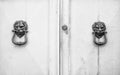 Lion head knockers on an old white wooden door Royalty Free Stock Photo