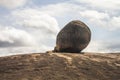 A lion rests by a rock Royalty Free Stock Photo