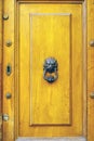 Lion`s head door knocker in a aged wooden door Royalty Free Stock Photo